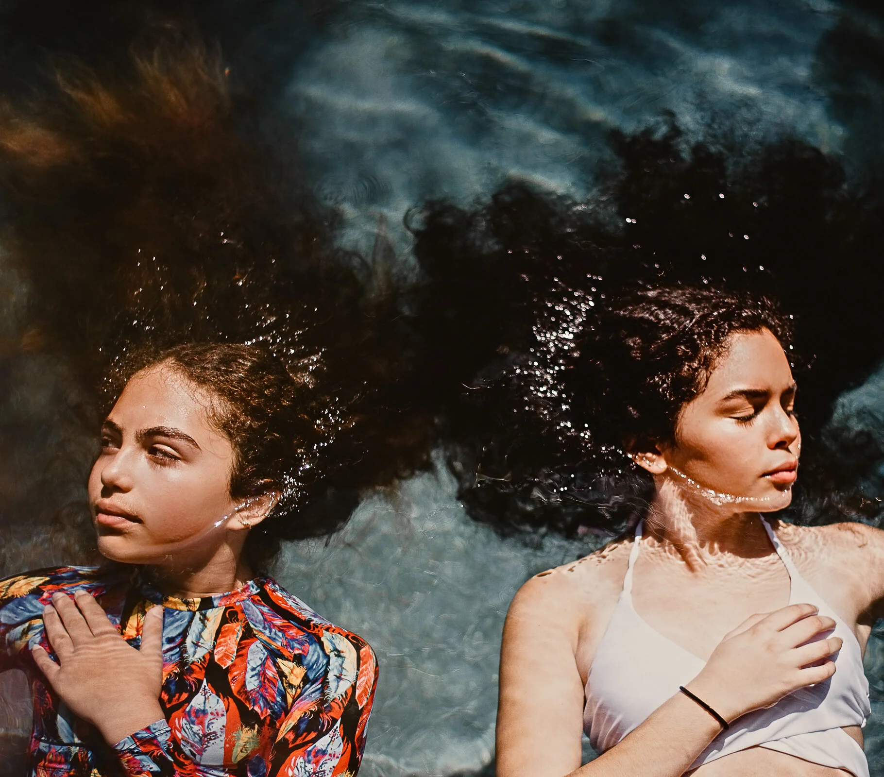 An amazing summer day at the pool. Teens, curly hair, models.
