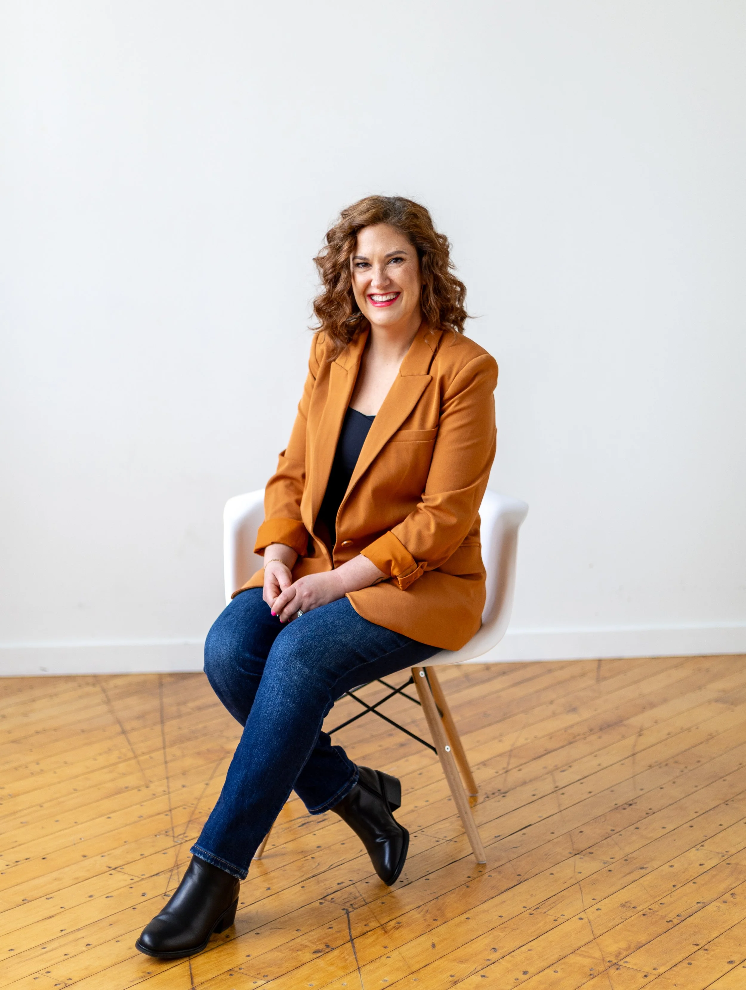 Becky Hunt sitting comfortably in a bright room, reflecting compassion and confidence after loss