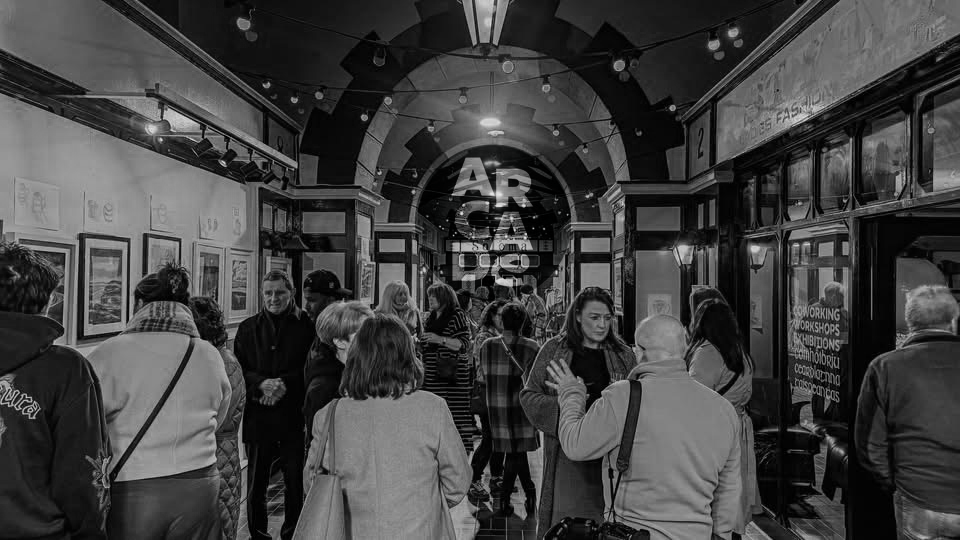 a view of the main hall in our arts arcade, an art exhibition and people enjoying the space
