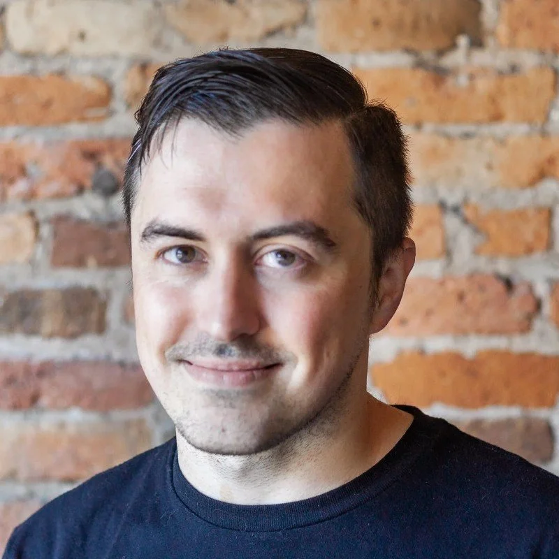 Portrait image of Brad Mitchell with a brick background
