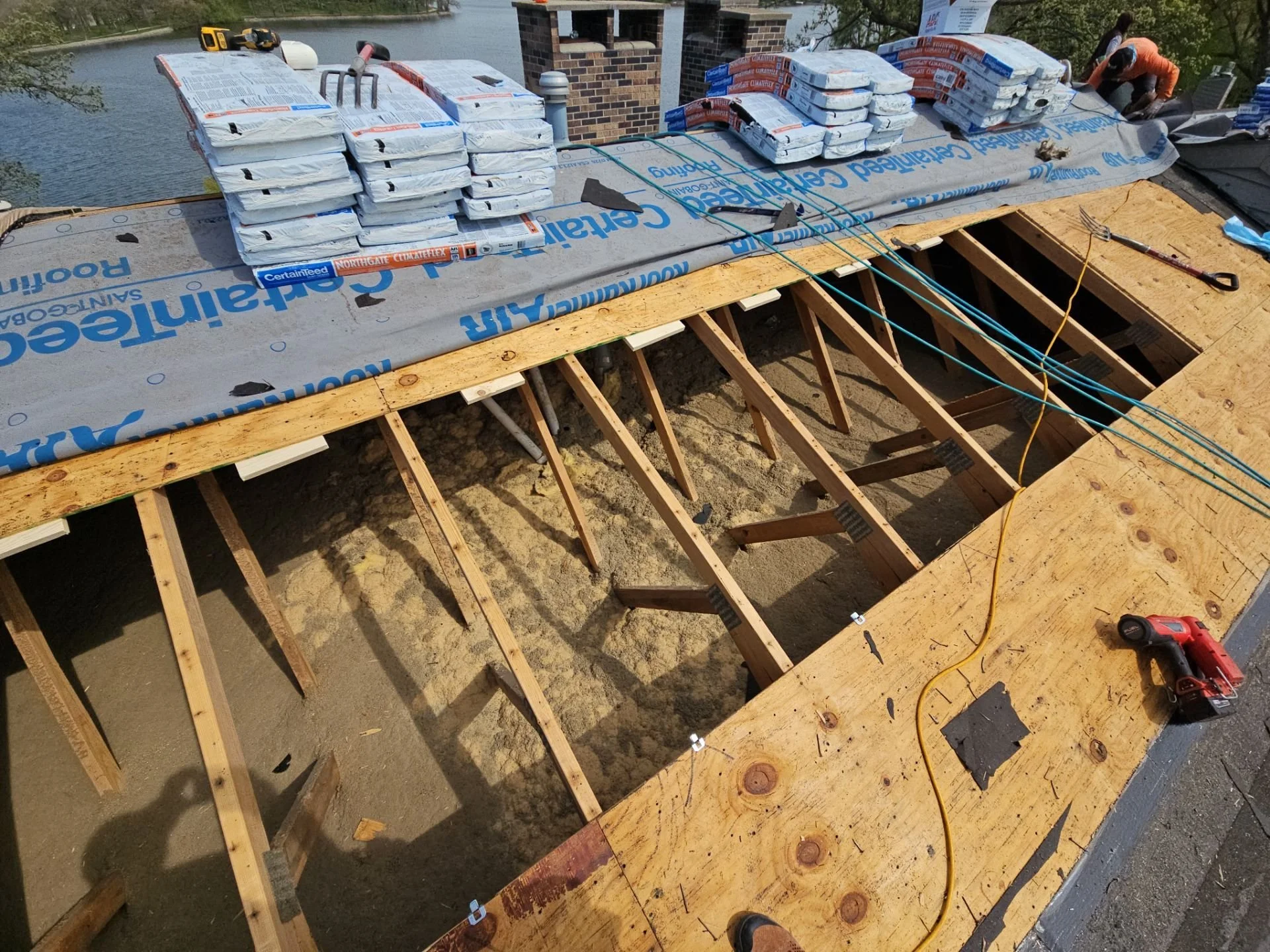 Roof decking repair and reinforcement in progress using Buckle Down Roofing system with cleats and underlayment for enhanced durability