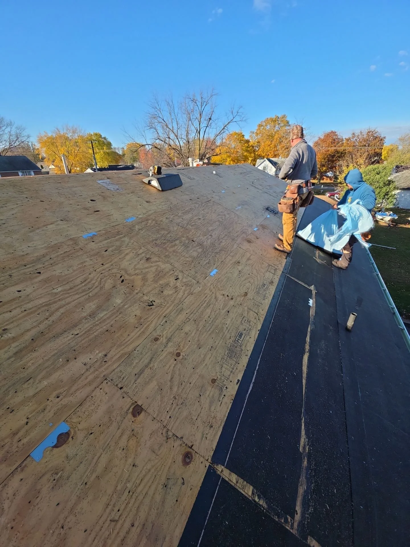 Buckle Down roofing cleat fastened over a split decking seam providing secure backing for metal roofing and preventing seam failure