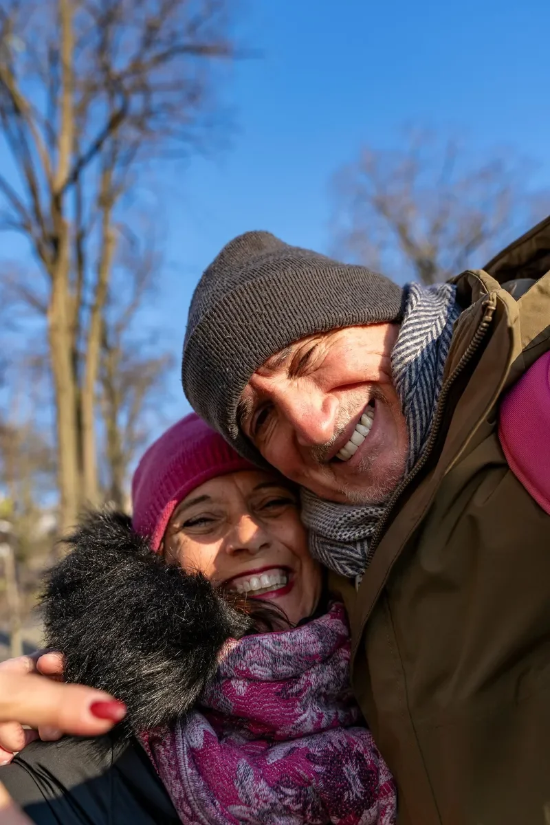 senior couple smiling and staying close together in the Dolomites