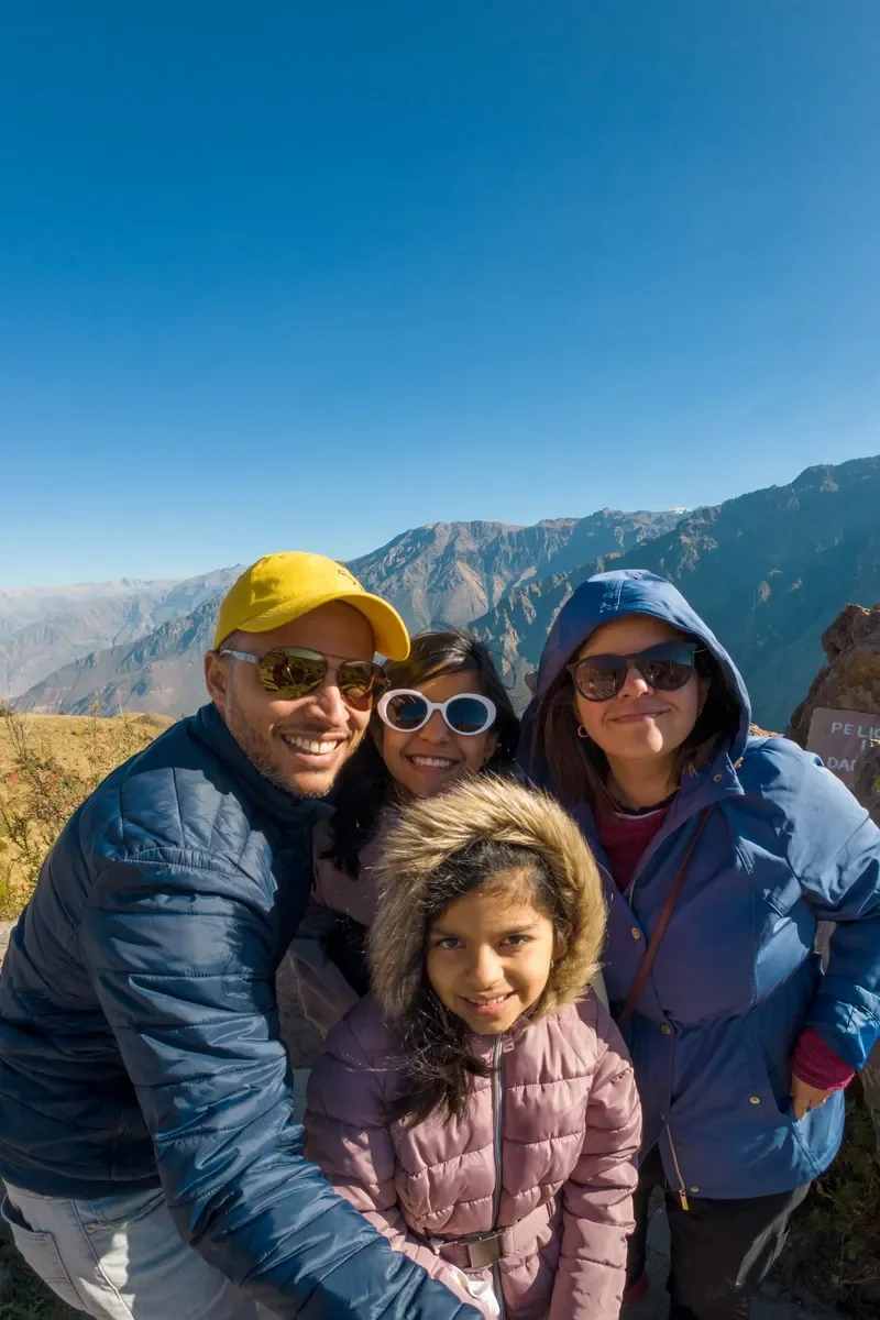 family picture on top of a mountain beautiful sunny day