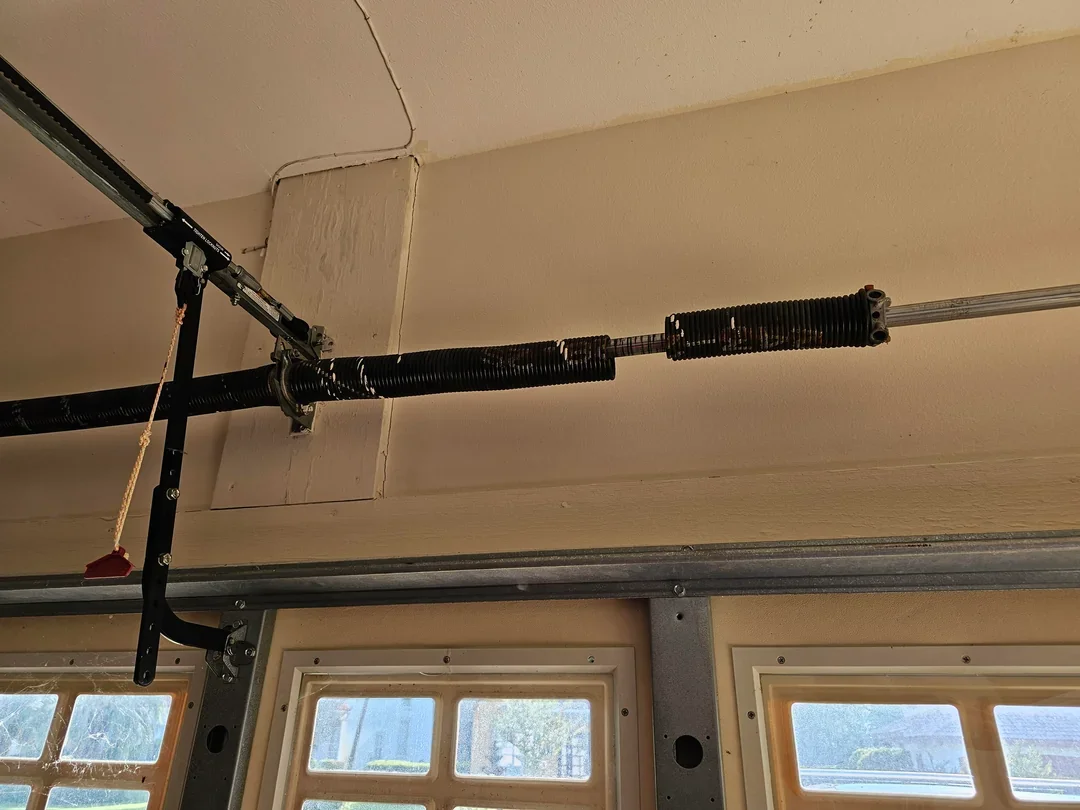 Garage door torsion spring and opener mechanism.