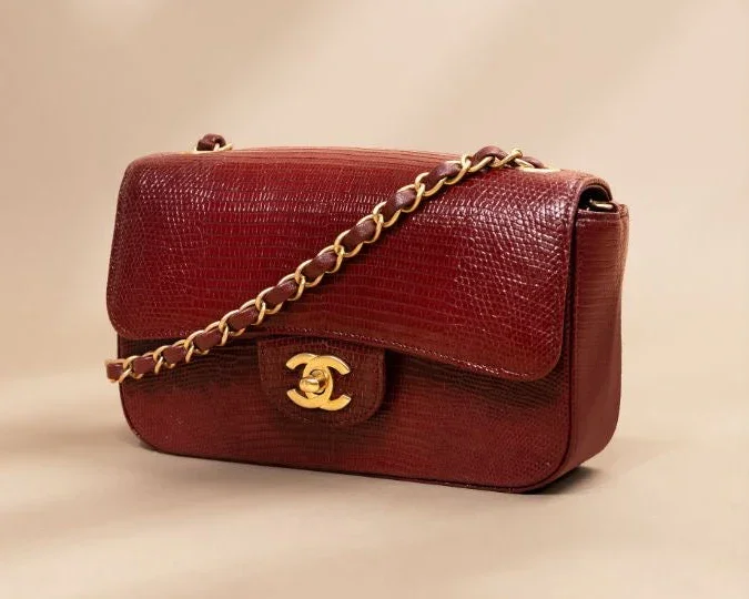 Red leather Chanel handbag with gold chain strap and logo clasp