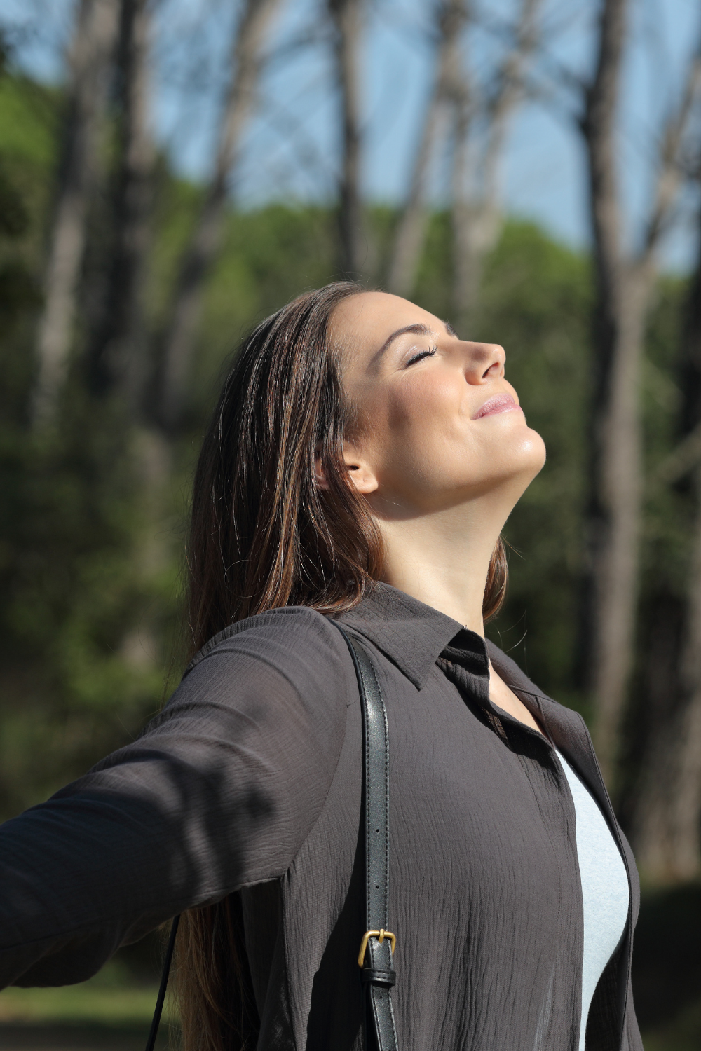 woman in 40s deep breathing outside