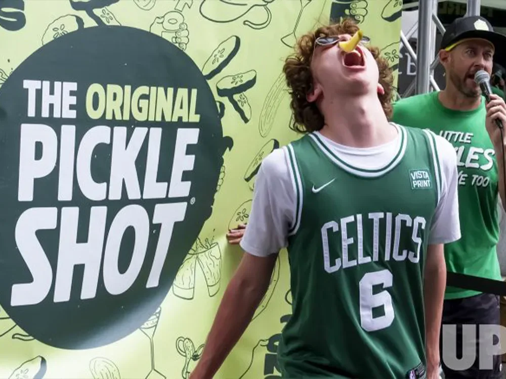 Guy catching pickle at Original Pickle Shot Picklesburgh