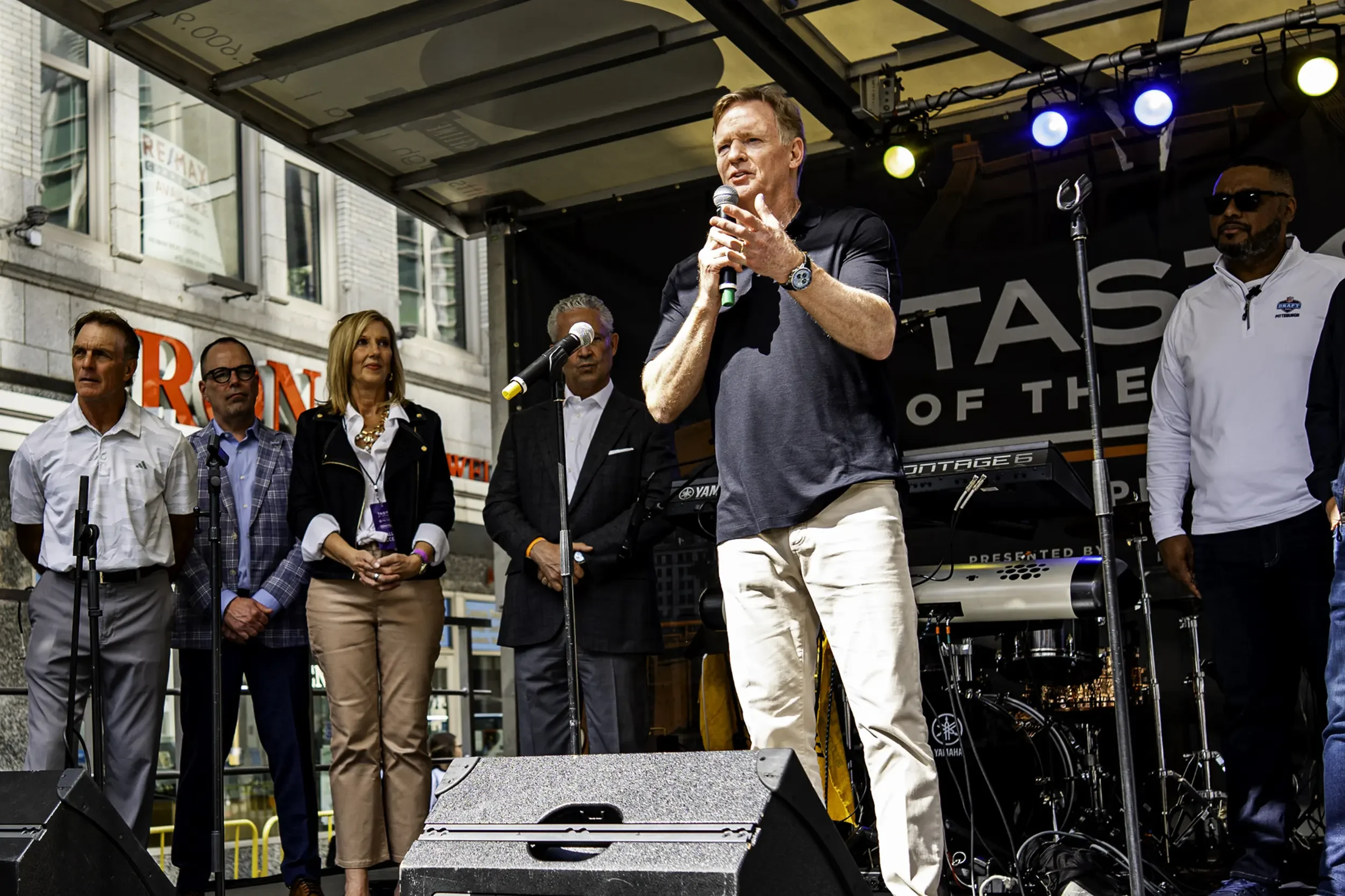 Roger Goodell Speaking on stage with others at Taste of the Draft