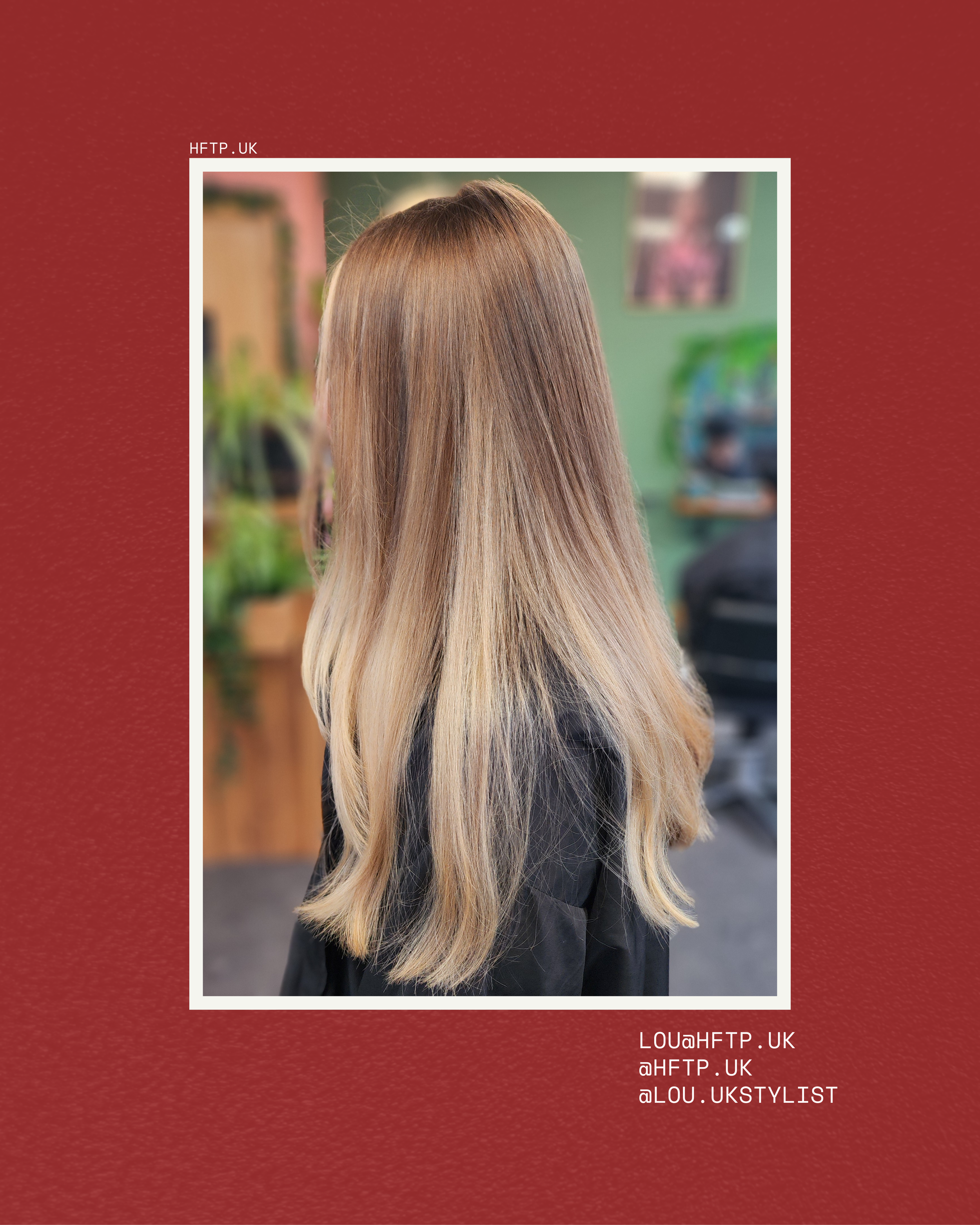 Back view of a woman with long, wavy blonde hair wearing a black top, indoors with a blurred background of green walls and people.