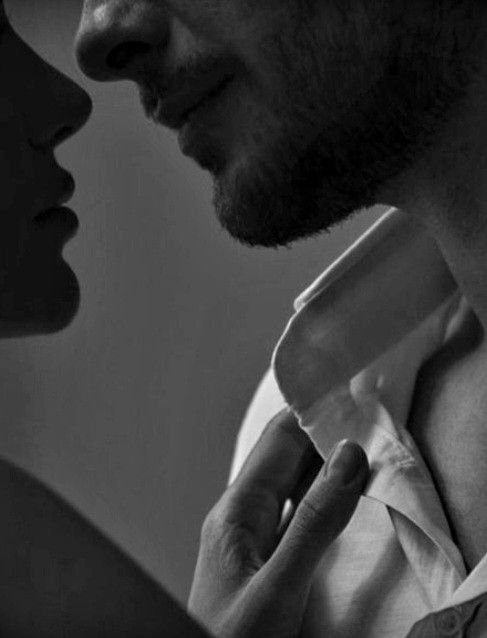 Two people close to each other, with their faces nearly touching, conveying intimacy.