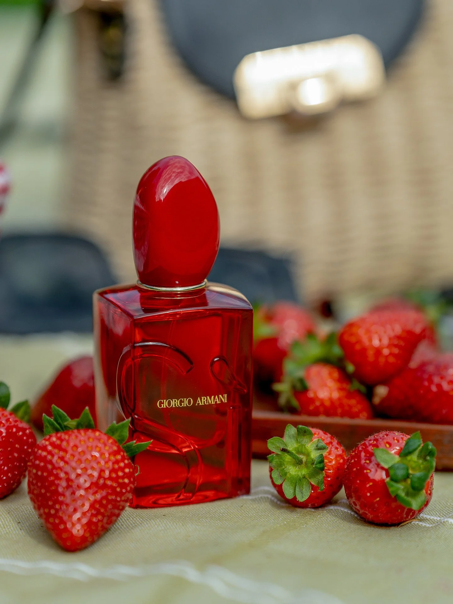 Giorgio Armani Si Red Musk surrounded by strawberries