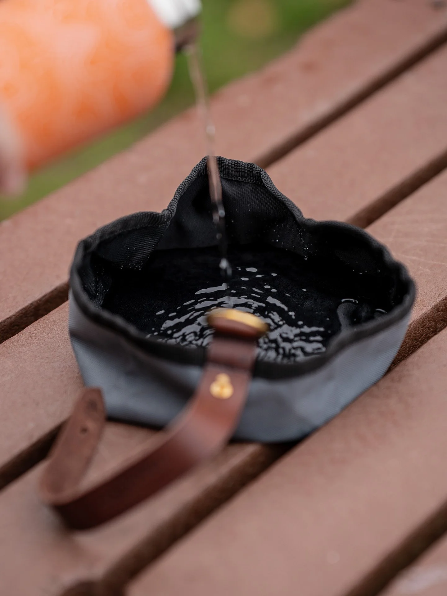 Ruff and Tumble foldable dog bowl with water being poured in it