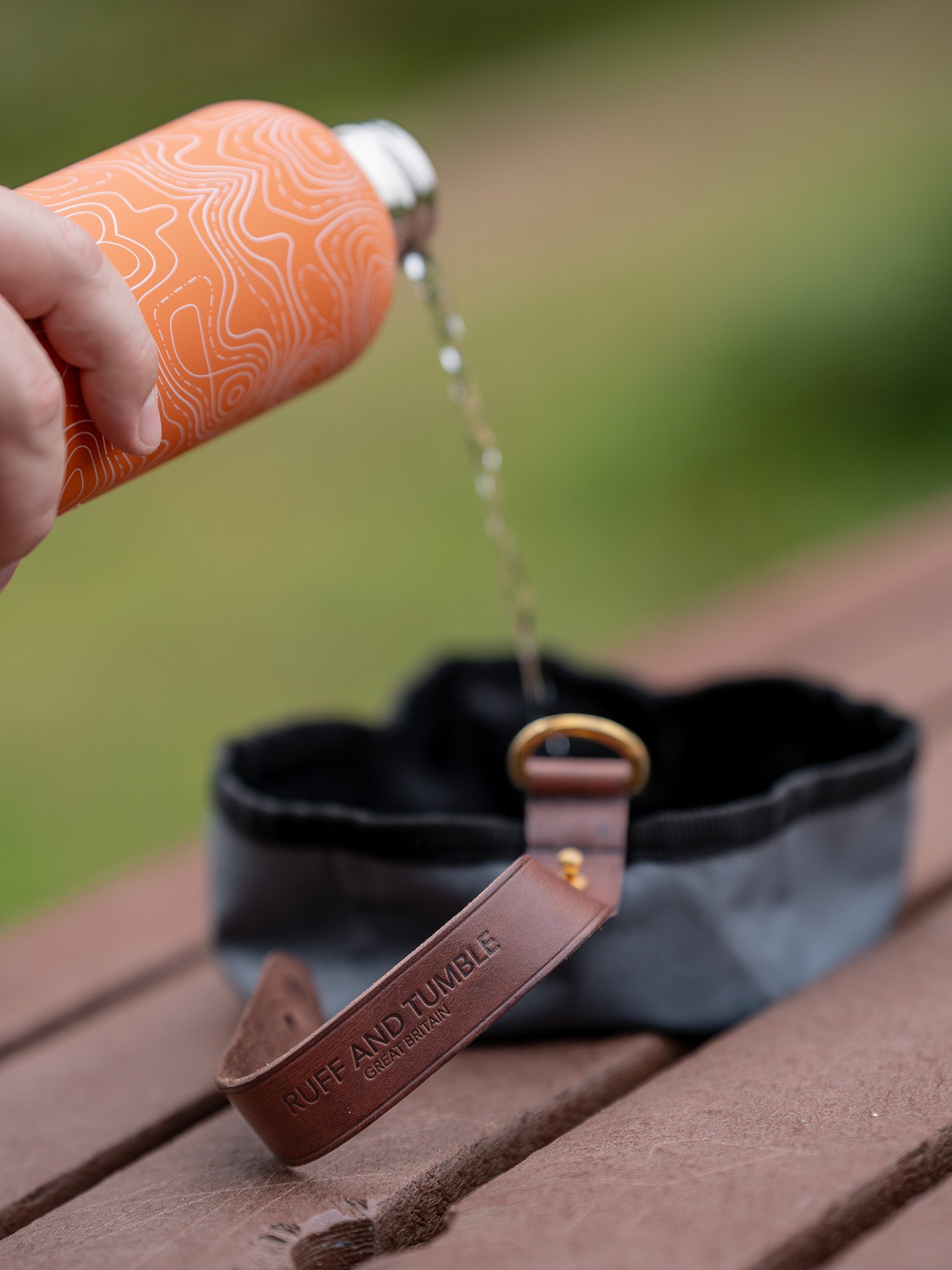 Ruff and Tumble foldable dog bowl with water being poured in it