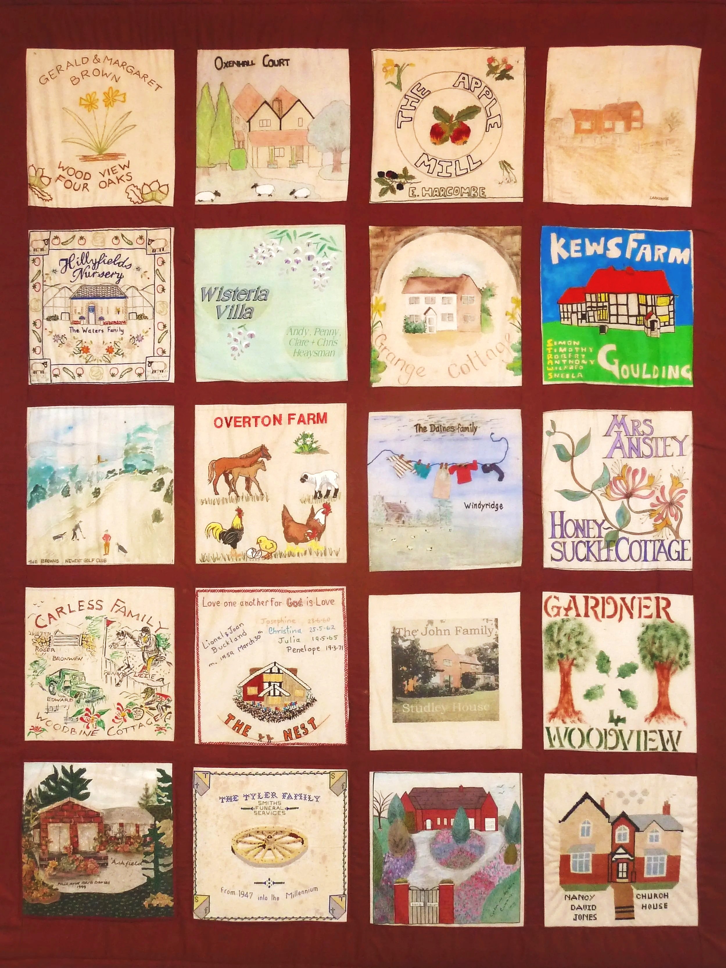 A quilt featuring 20 hand-stitched and painted fabric squares, each depicting different houses, farms, family names, and decorative designs, arranged in a grid pattern.