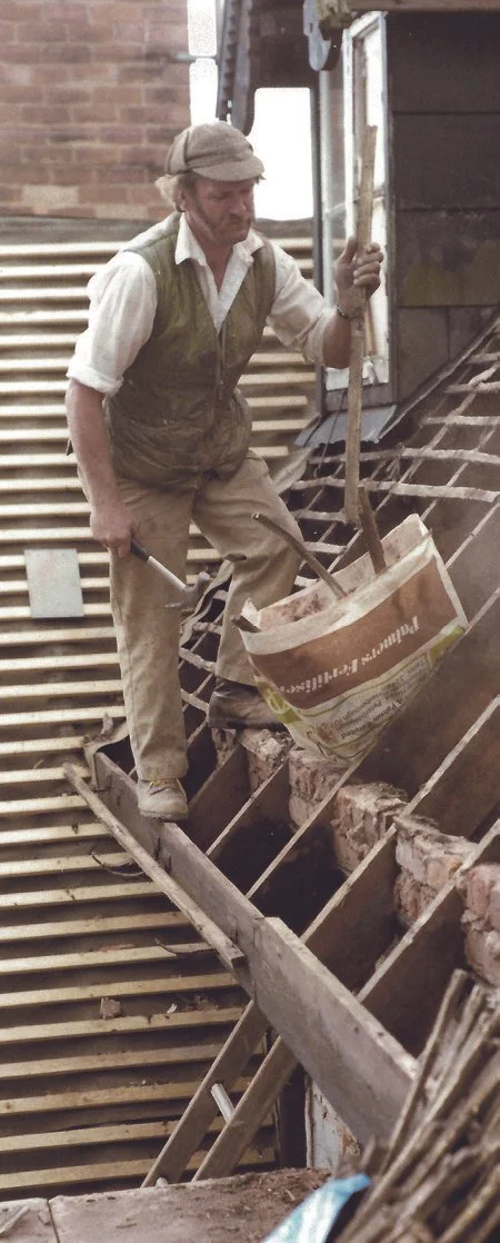 Builder John Williams removing tiles whilst renovating Winters Farm
