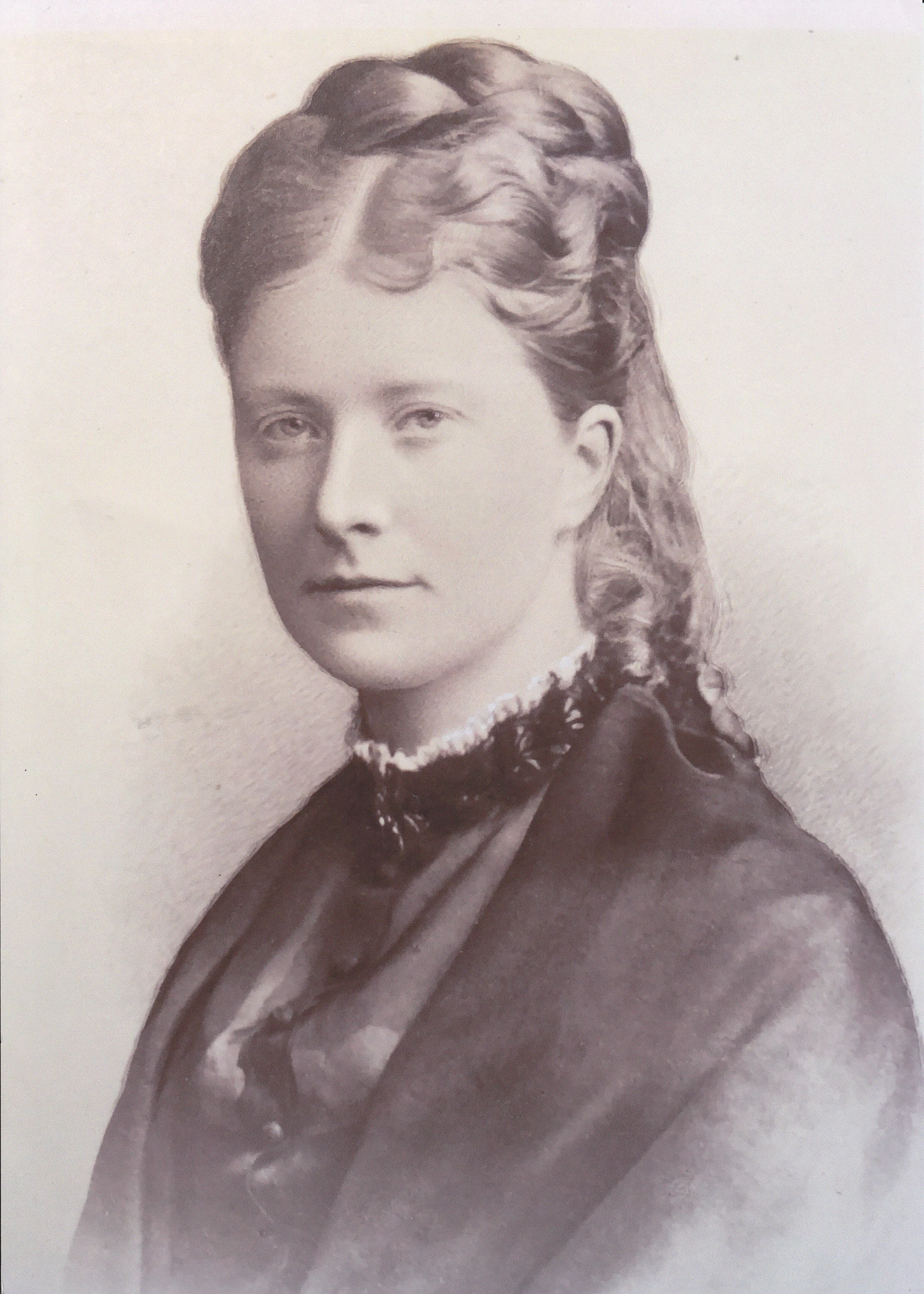 A black and white portrait of a young woman with styled hair, wearing a high-collared dress and lace choker, looking directly at the camera.