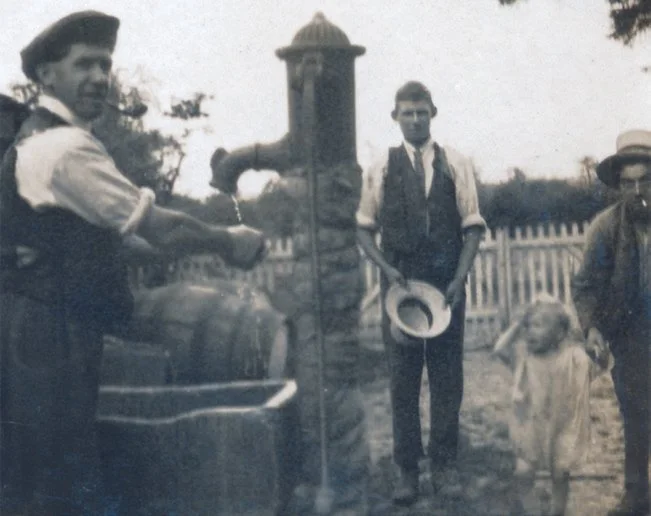 The Chapman family washing at the pump
