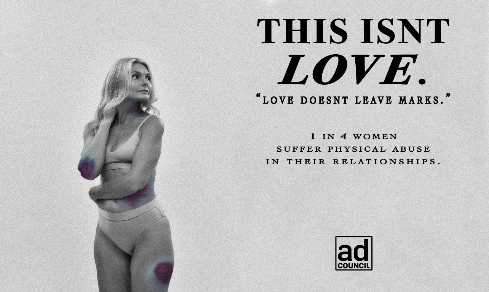 Black and white photo of a woman with colored mark effects on her arm, hand on neck, looking away, with a serious expression. The background has text stating, "This isn't love. Love doesn't leave marks." and information about domestic violence awaren