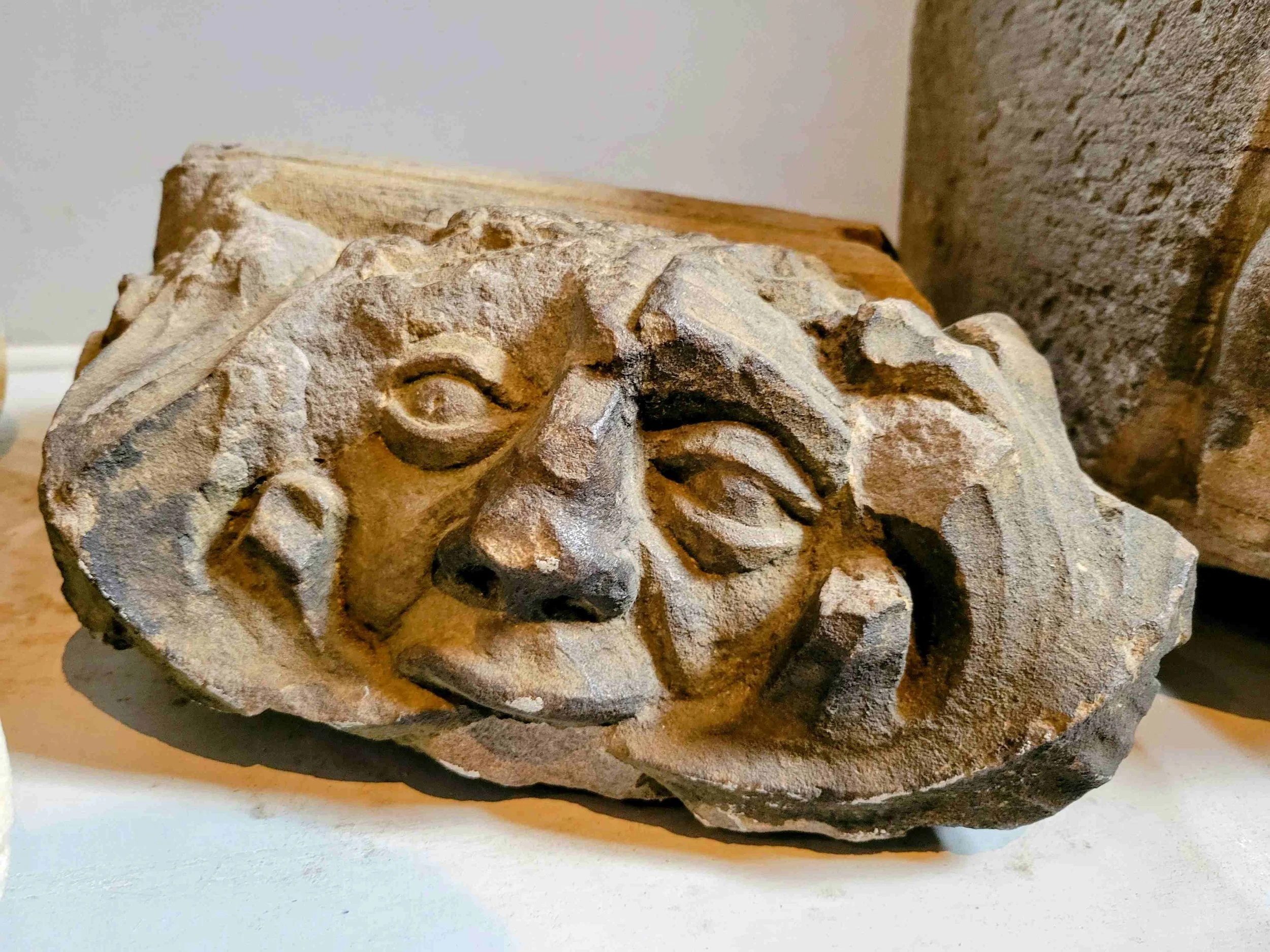 Close-up photo of a carved stone sculpture portraying a human face at Glasgow Cathedal in Scotland.