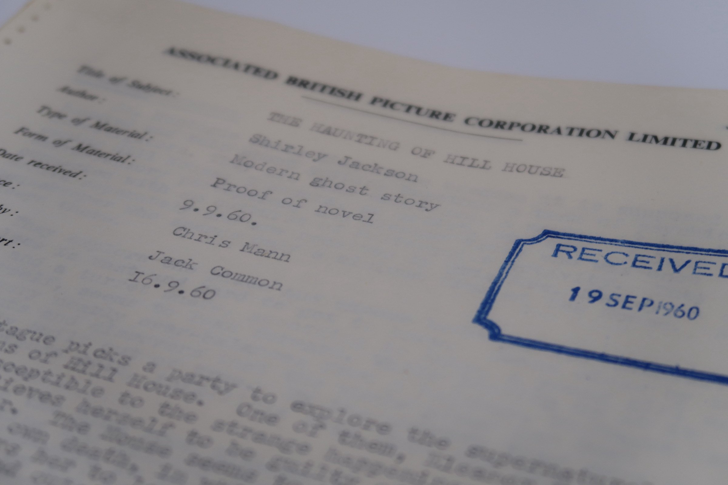 Close-up photo of a document with a blue stamp indicating receipt date of September 19, 1960, and text mentioning Shirley Jackson's modern ghost story titled "The Haunting of Hill House."
