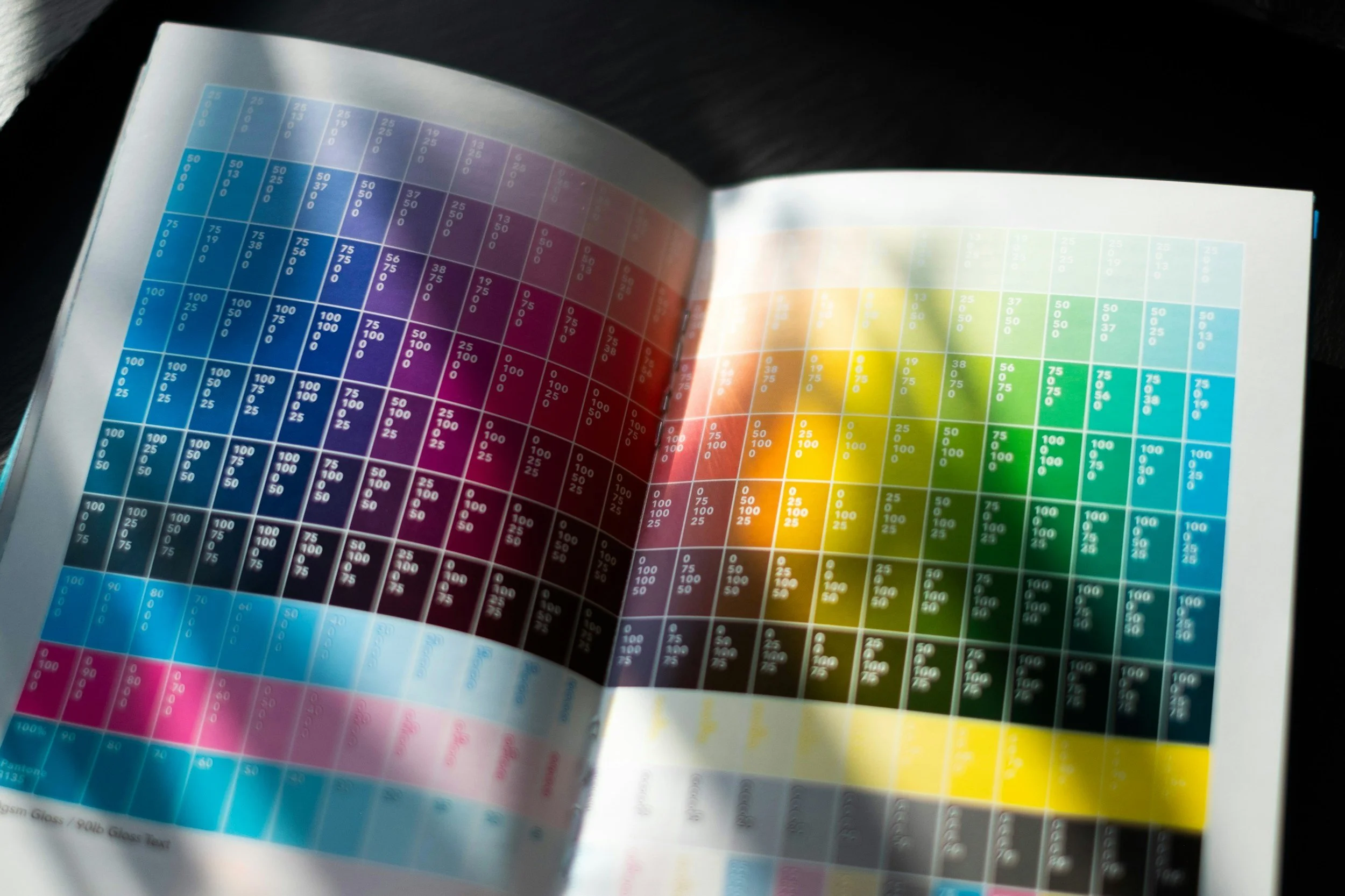 Open magazine showing a colorful color chart with various shades and corresponding numerical values.