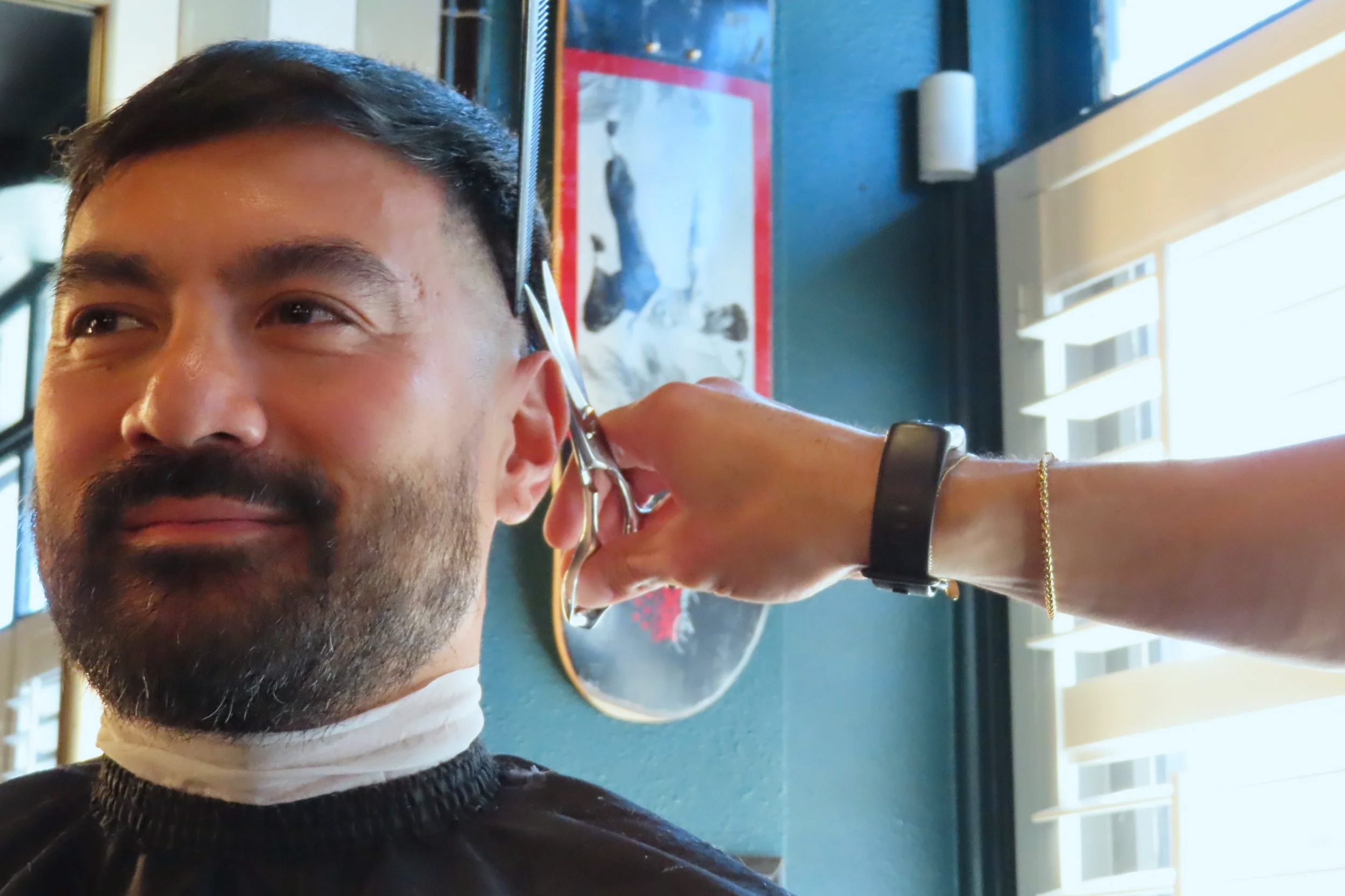 Man getting a haircut at a salon.