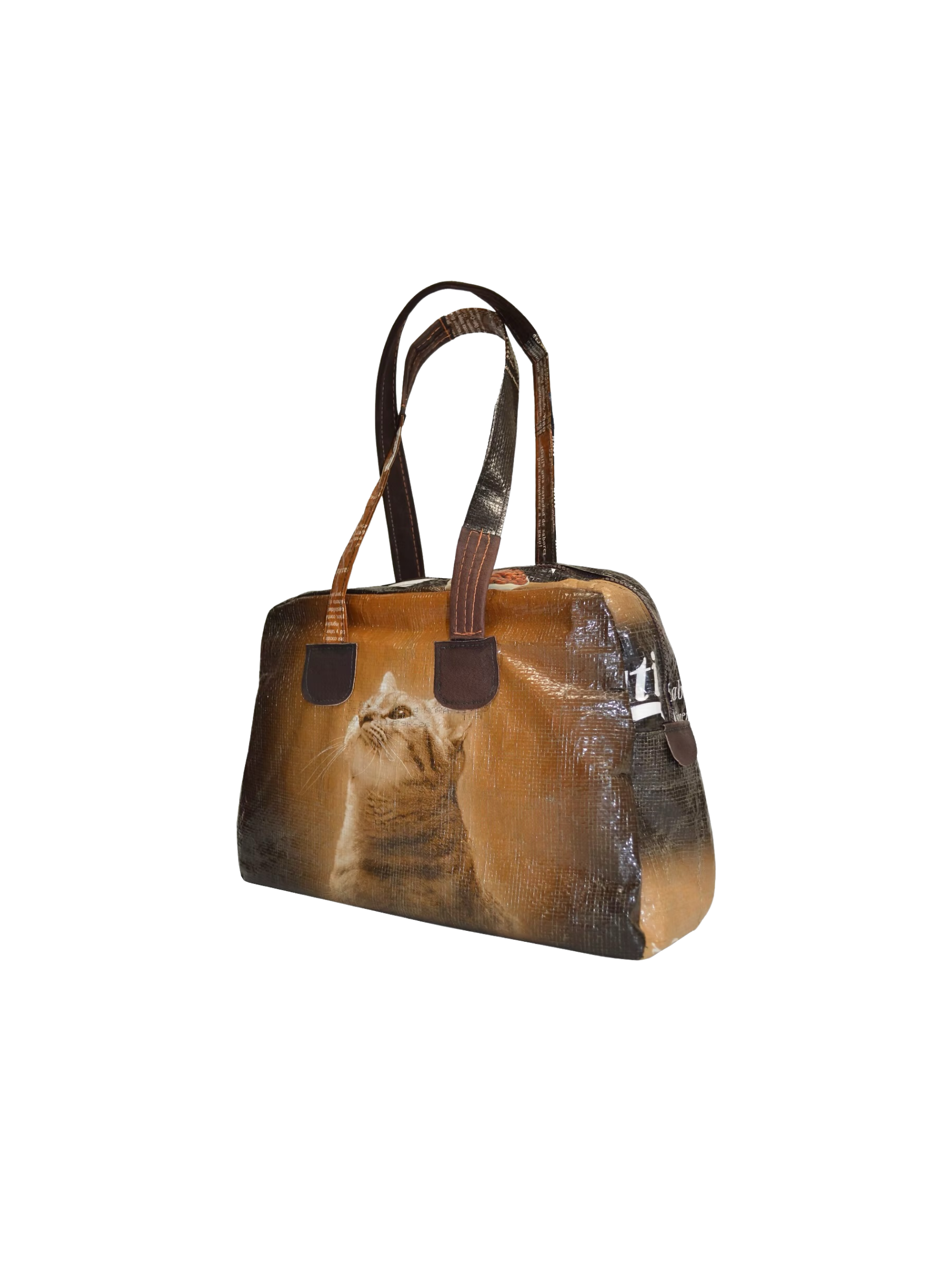 A brown handbag featuring a printed image of a cat on its surface.