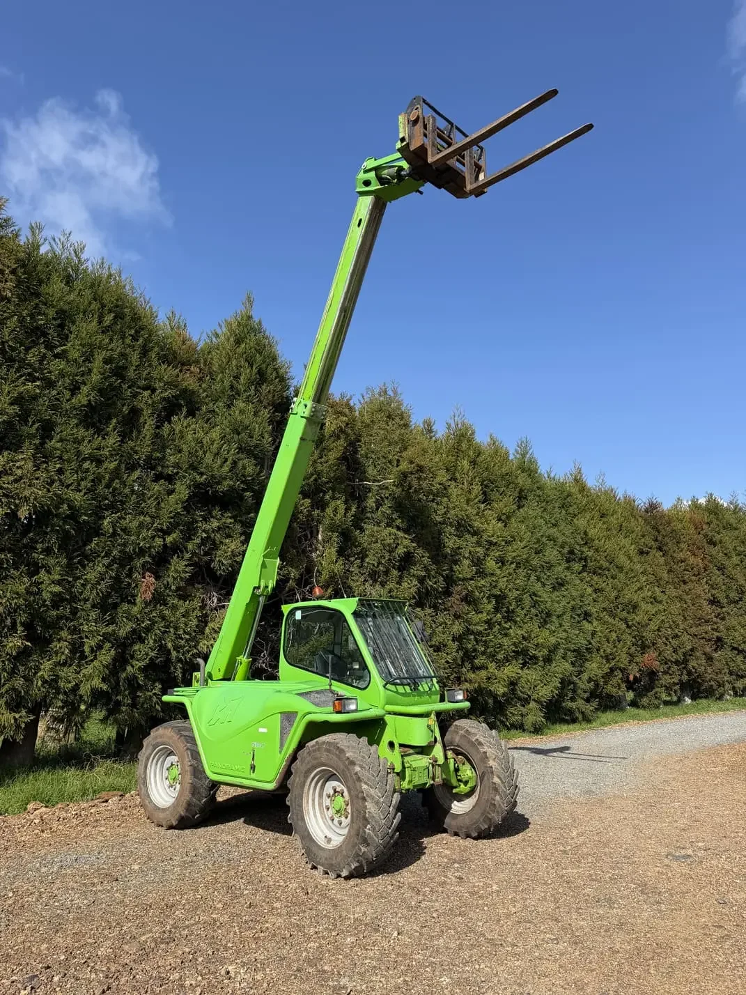 Merlo P34.7 telehandler with boom raised and pallet forks attached