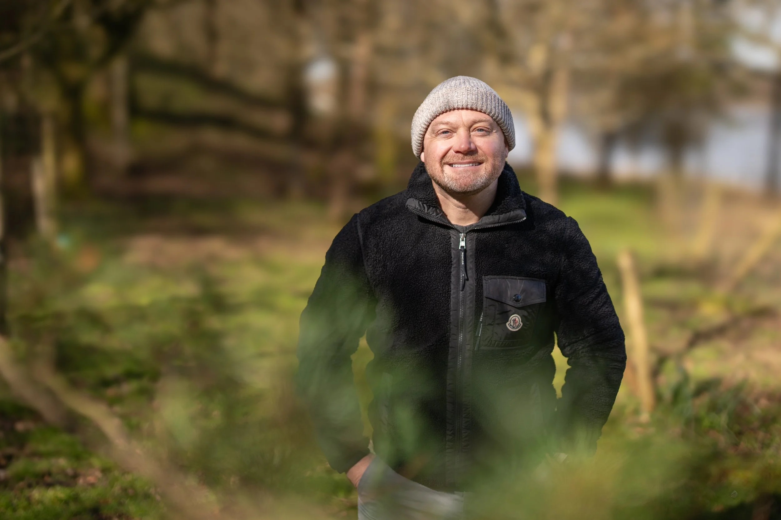 Image of Mike Hamilton in the countryside in a black fleece top and grey hat