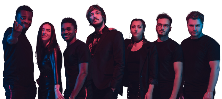 Group of seven diverse young adults posing against a dark background with colorful lighting.