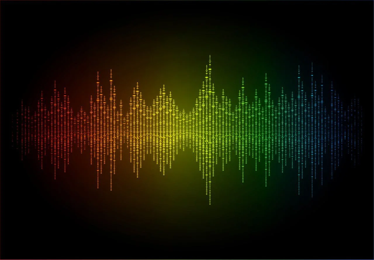A digital audio equalizer visualizer showing colorful sound wave patterns in red, yellow, green, and blue on a black background.