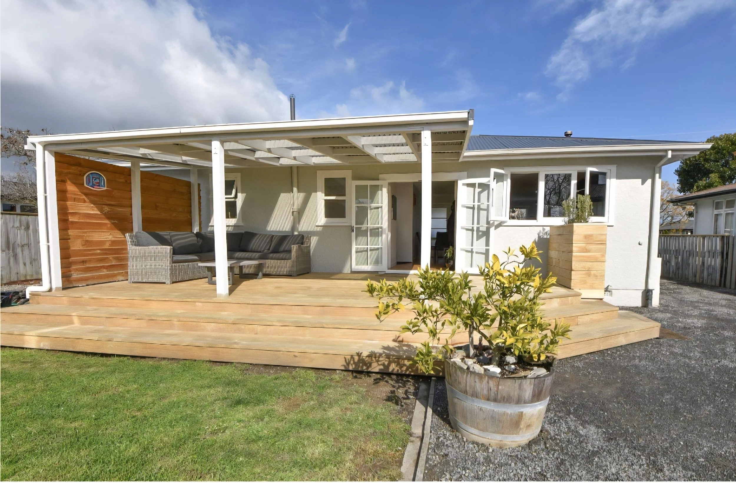 Outside after renovation: decking, verandah and privacy wall