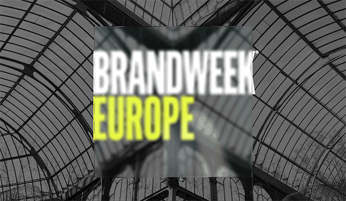 Brandweek Europe conference logo displayed inside a large glass atrium.
