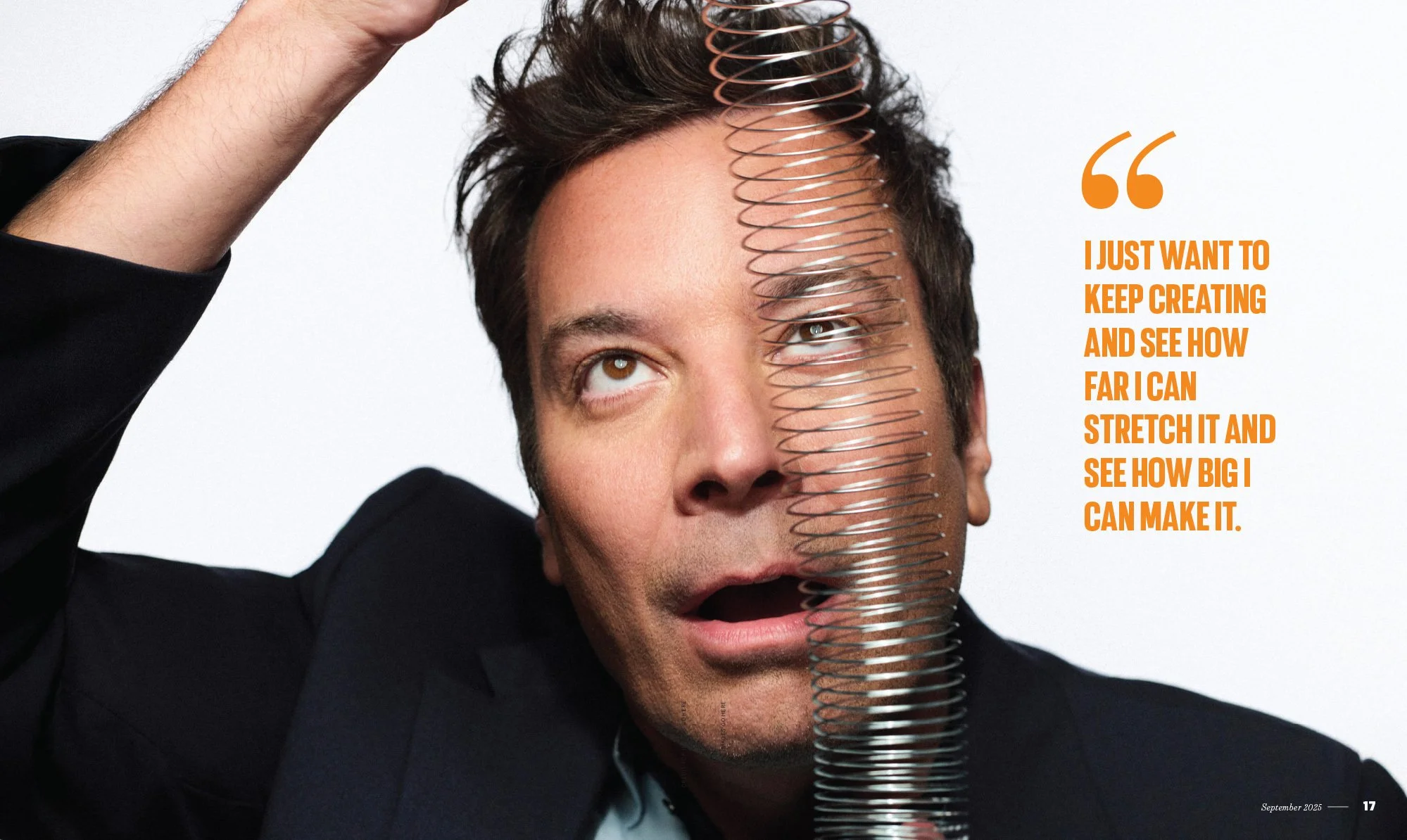 A man with brown hair and a surprised expression, holding a metal coil spring over part of his face. There is a quote in orange text on the right side that reads, 'I just want to keep creating and see how far I can stretch it and see how big I can ma