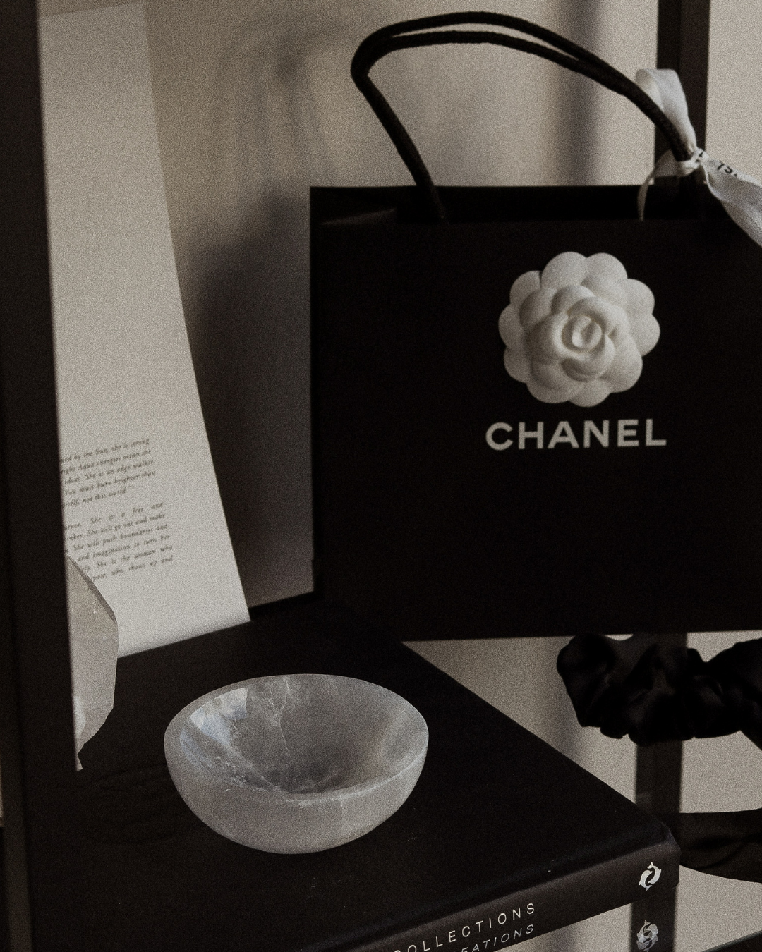 Chanel bag on a shelf with a crystal bowl