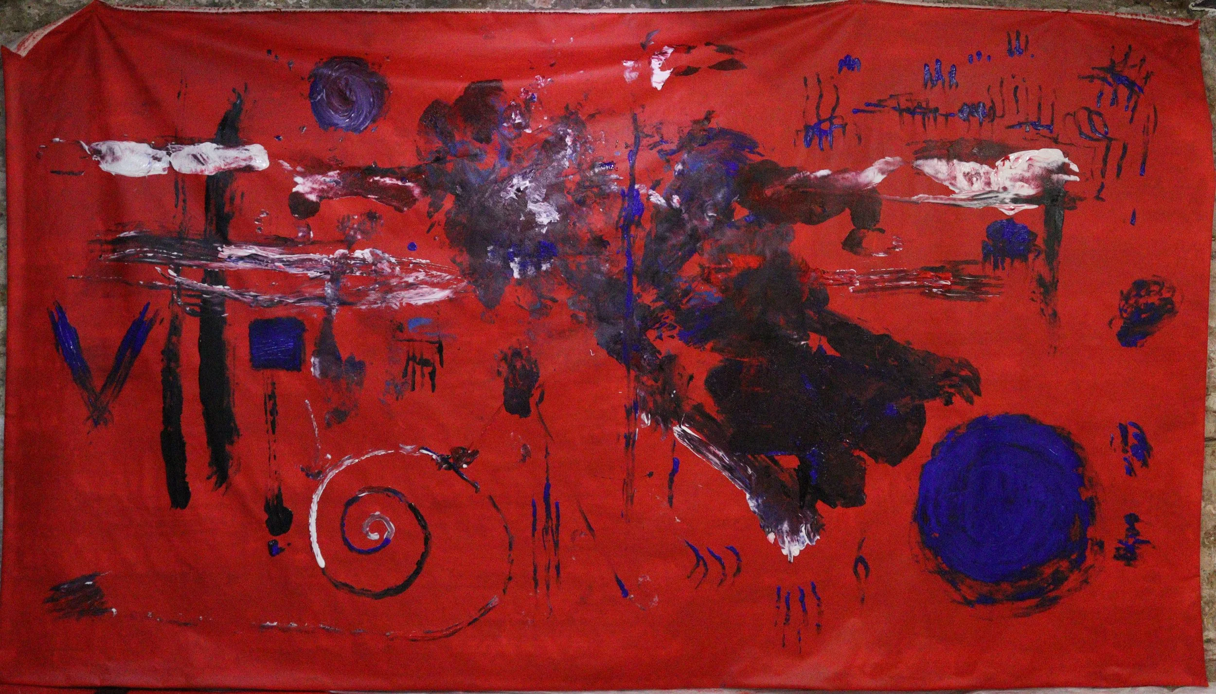Abstract painting with red background, black, white, and blue paint splatters, shapes, and scribbles.