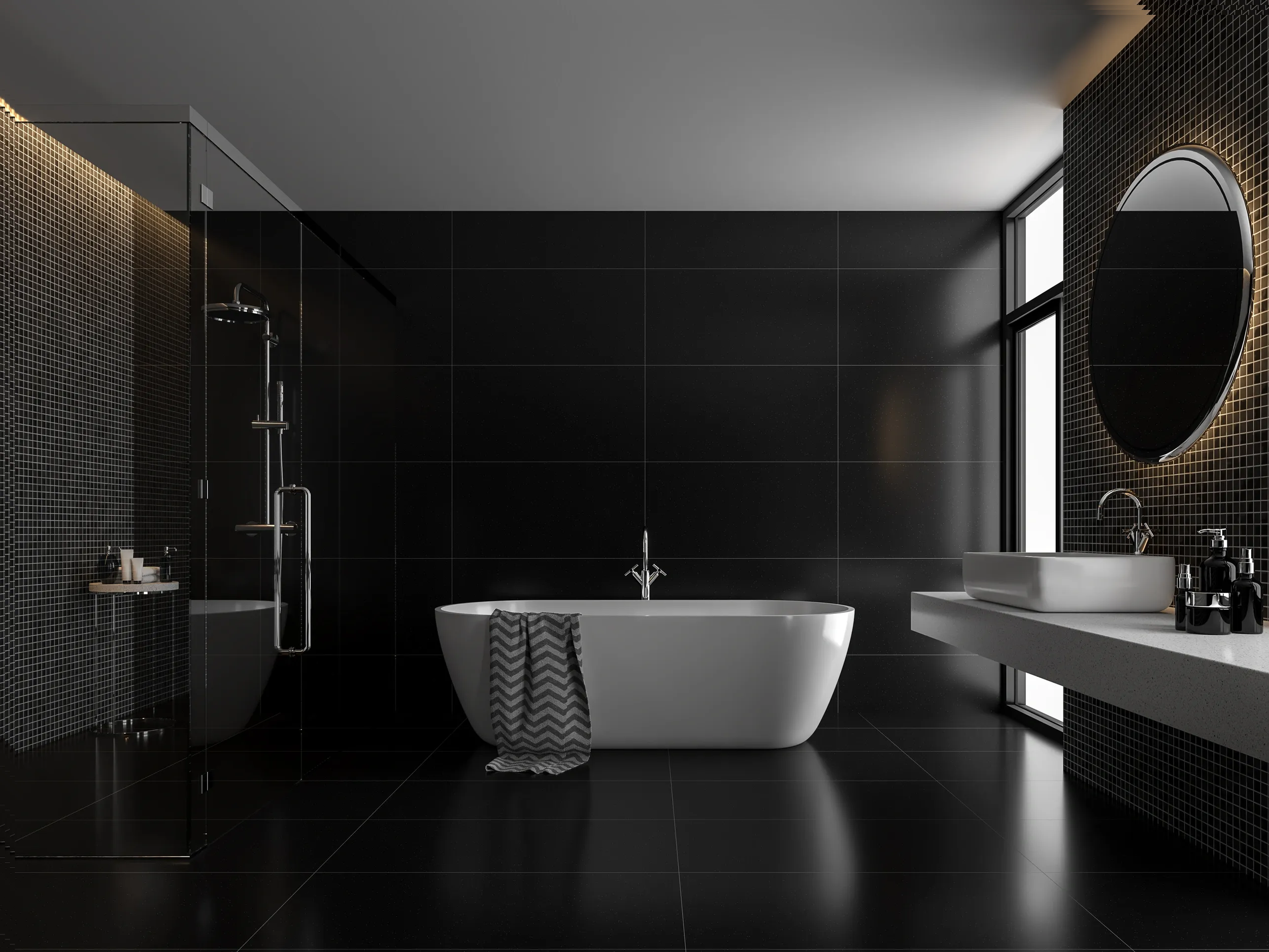 Modern black-tiled bathroom with bathtub, walk-in shower, and white vanity with round mirror.