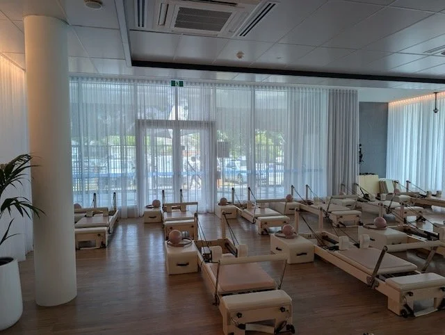 Custom window furnishings by Evans Curtains and Blinds installed at the PARC Frankston Pilates studio with varying ceiling heights.