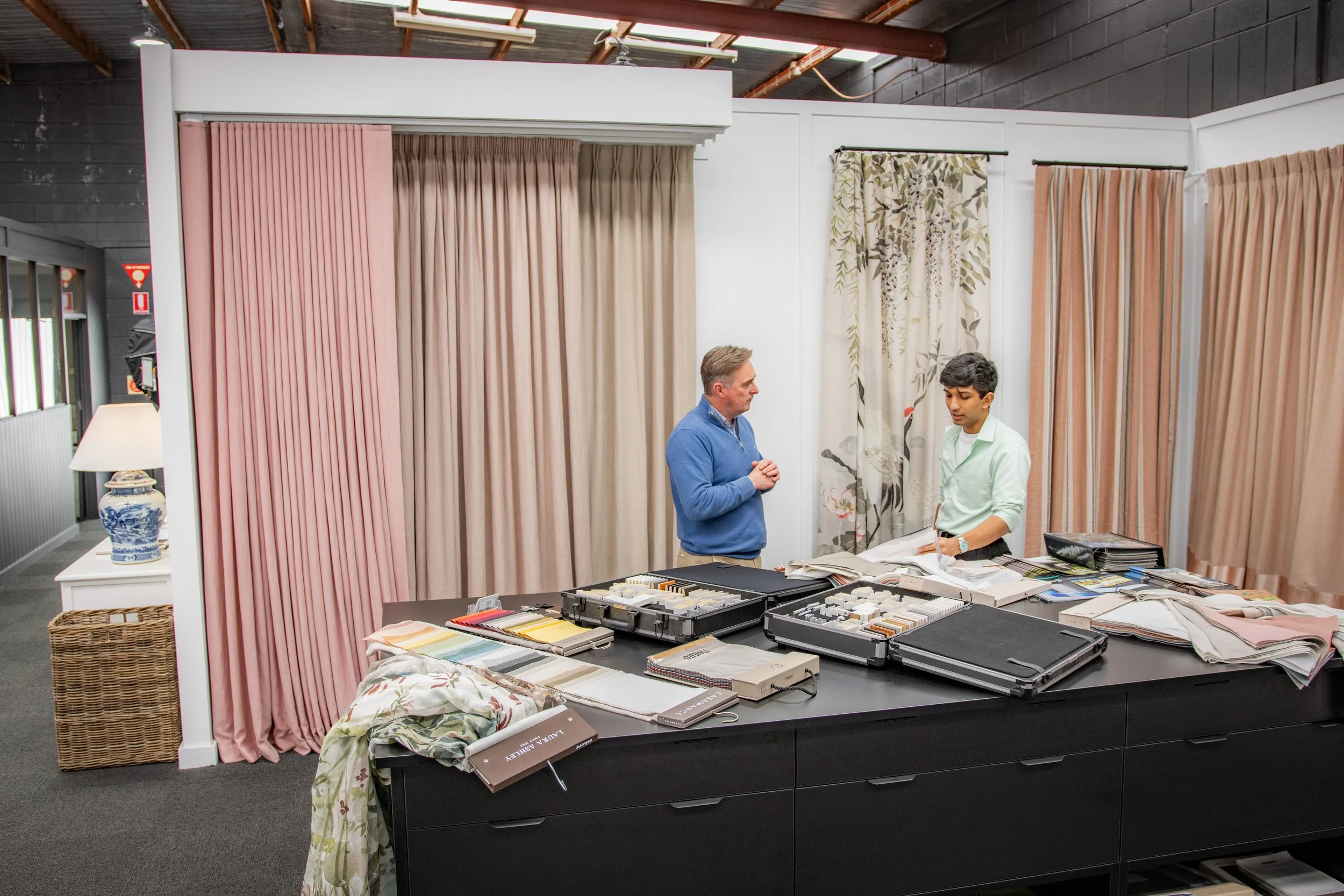 Exploring curtain fabrics, colours and finishes with the Evans Curtains and Blinds team in the showroom.
