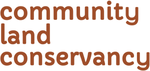 Text reading 'community land conservancy' in brown font on a black background.