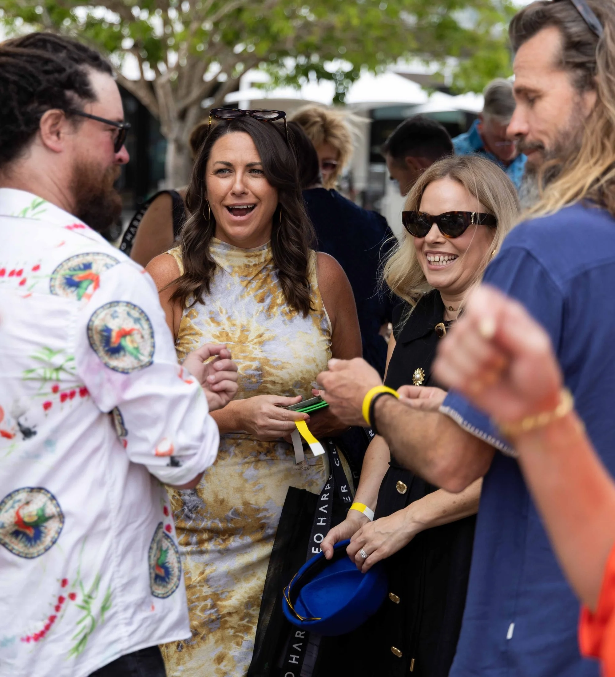 Guests laughing and chatting together at The Rolling Lunch 2026, Sanctuary Cove