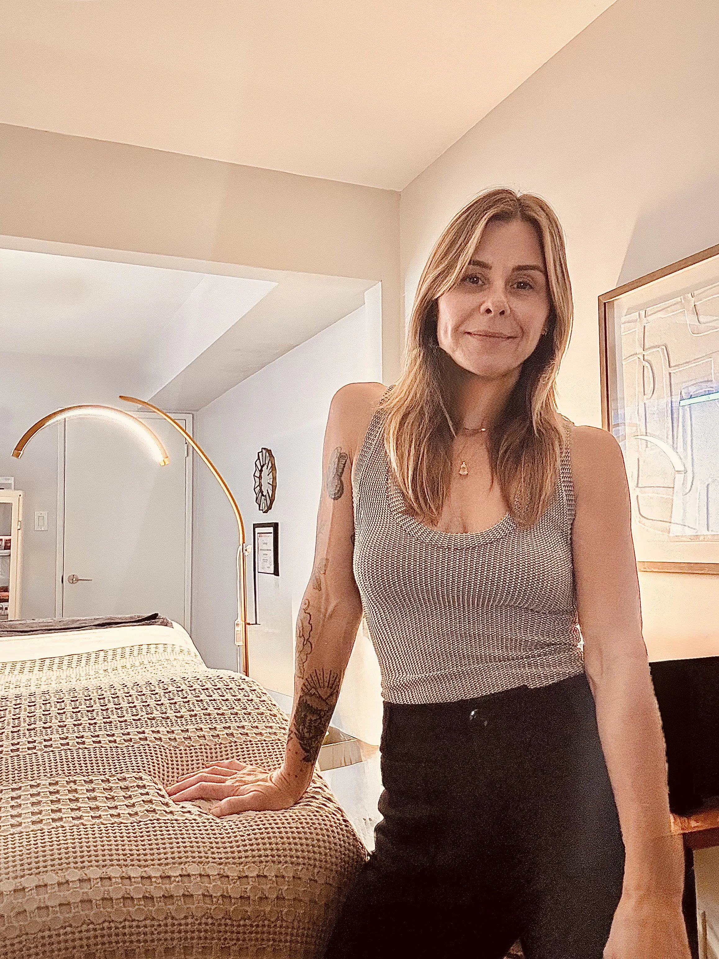 An esthetician standing in her treatment room