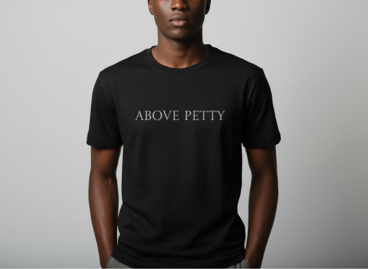 Person wearing a black T-shirt with the words "ABOVE PETTY" printed on the front.