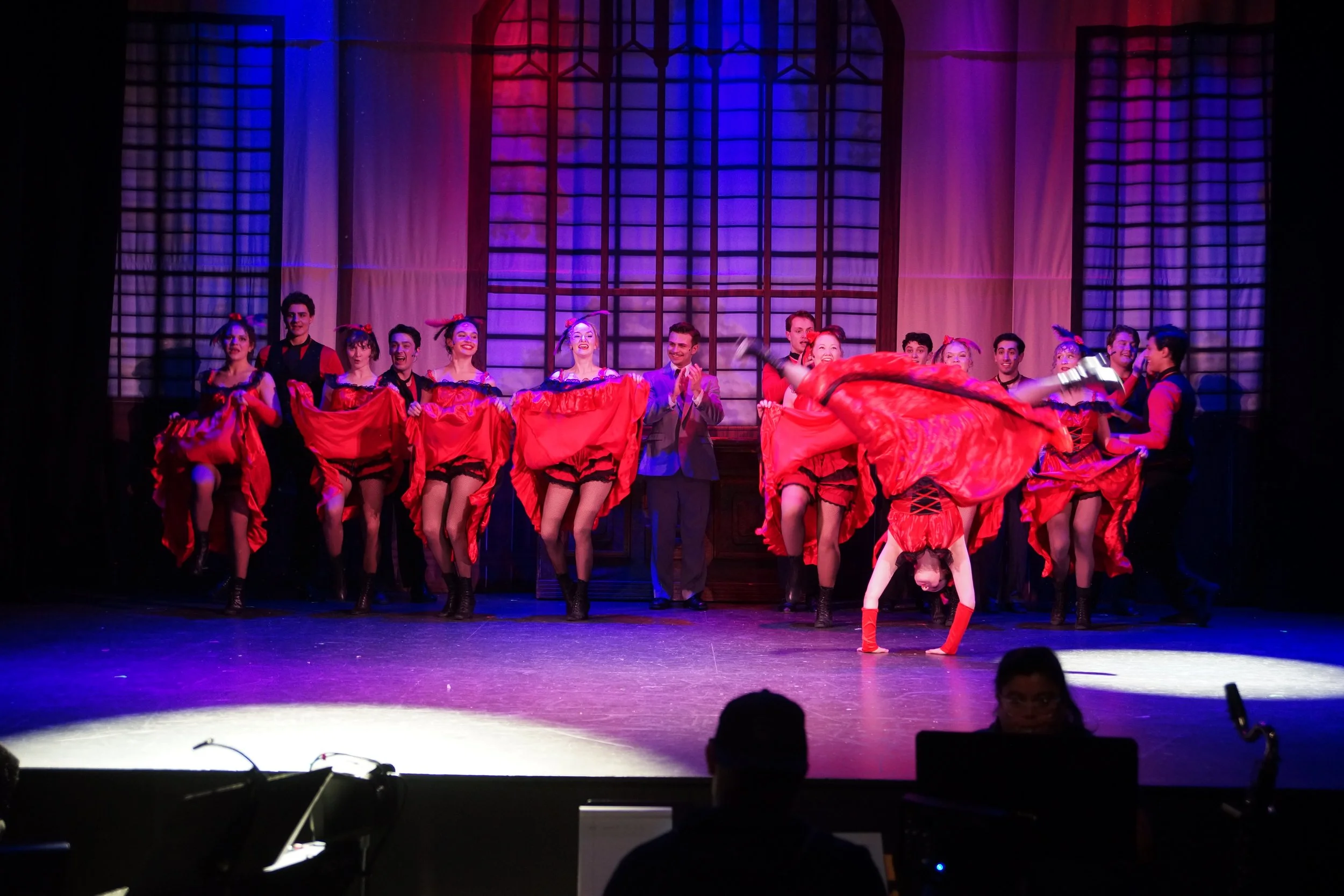 Makena Mitchell cartwheeling in Woodstock Playhouse's "Can-Can"