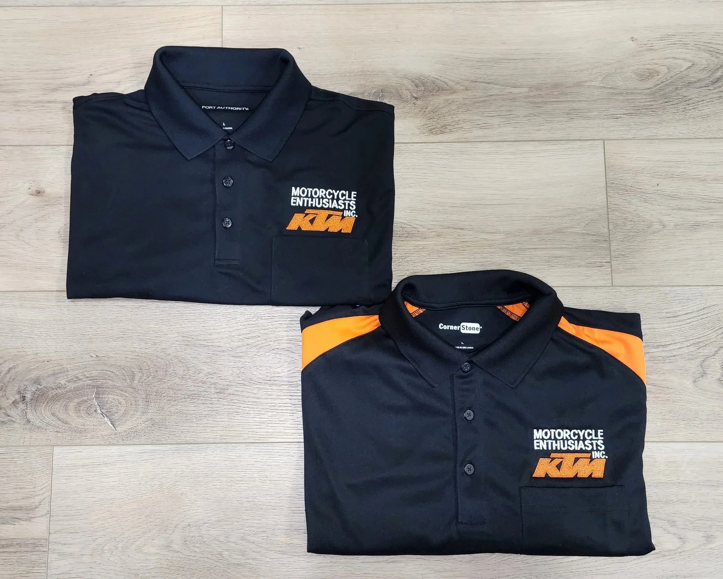 black and black and orange polo shirts with a business logo embroidered on a left chest.