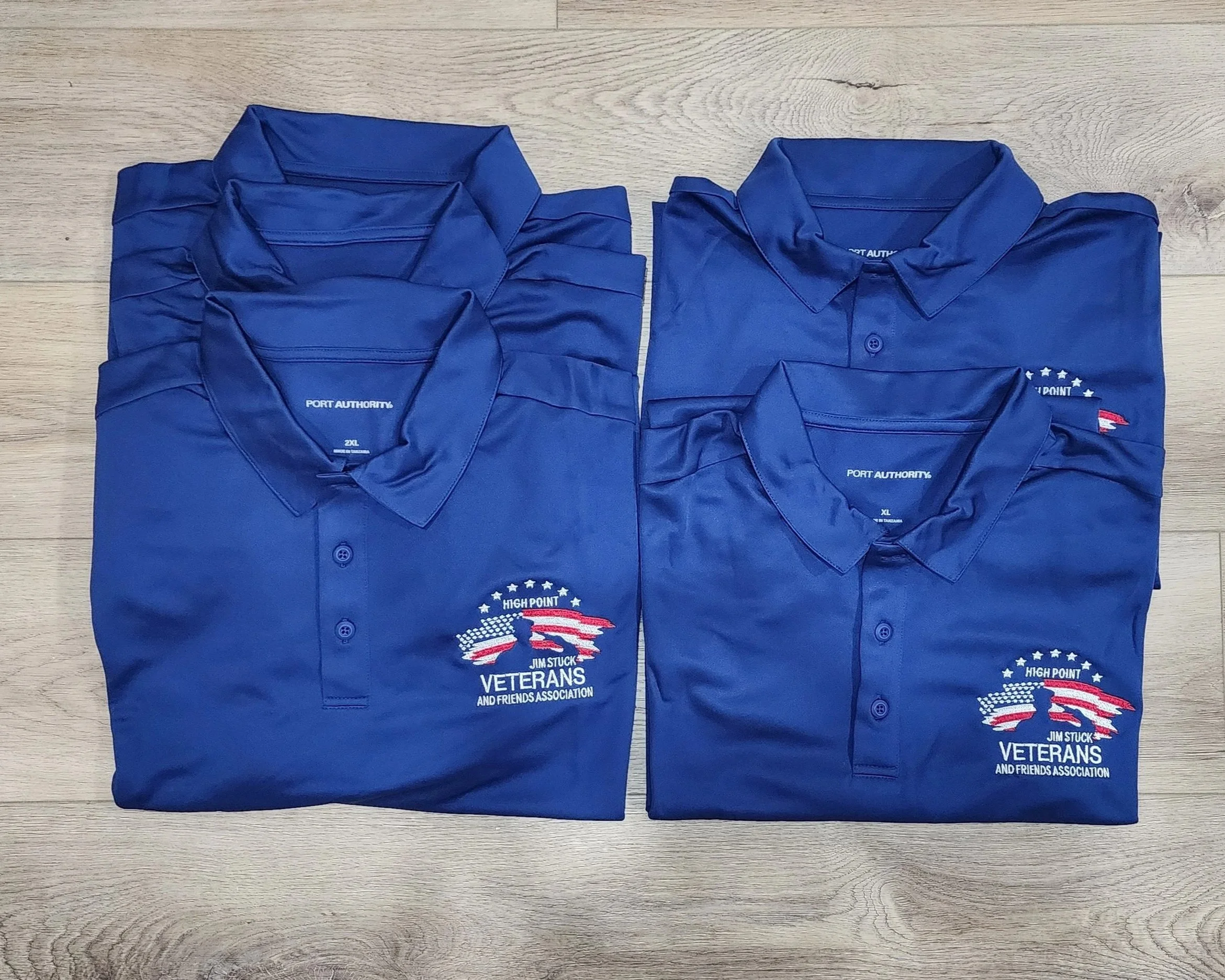 Royal blue polo shirts with a business logo embroidered on the left chest