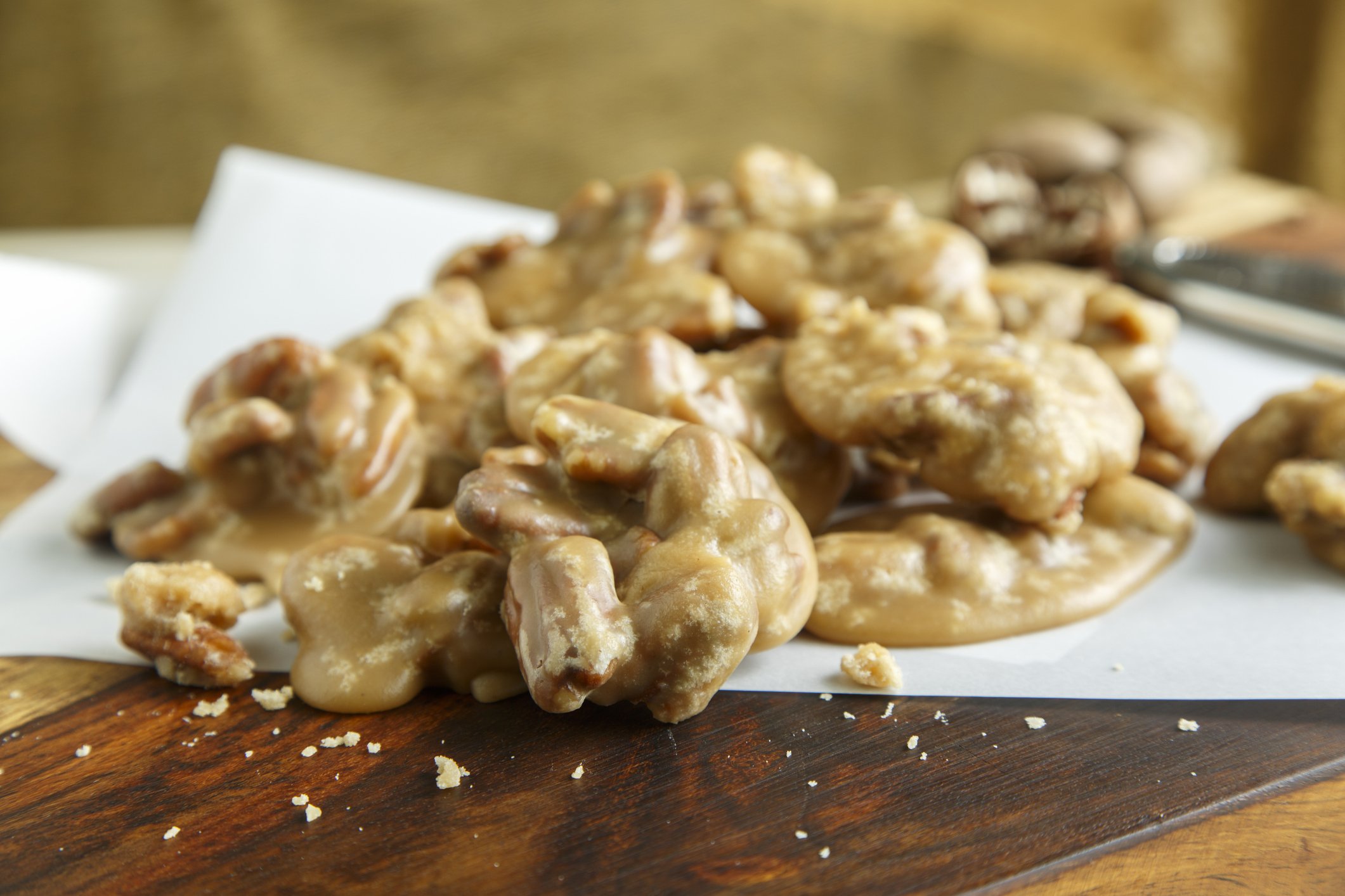 Pecan Pralines arranged on parchment paper on a wooden surface