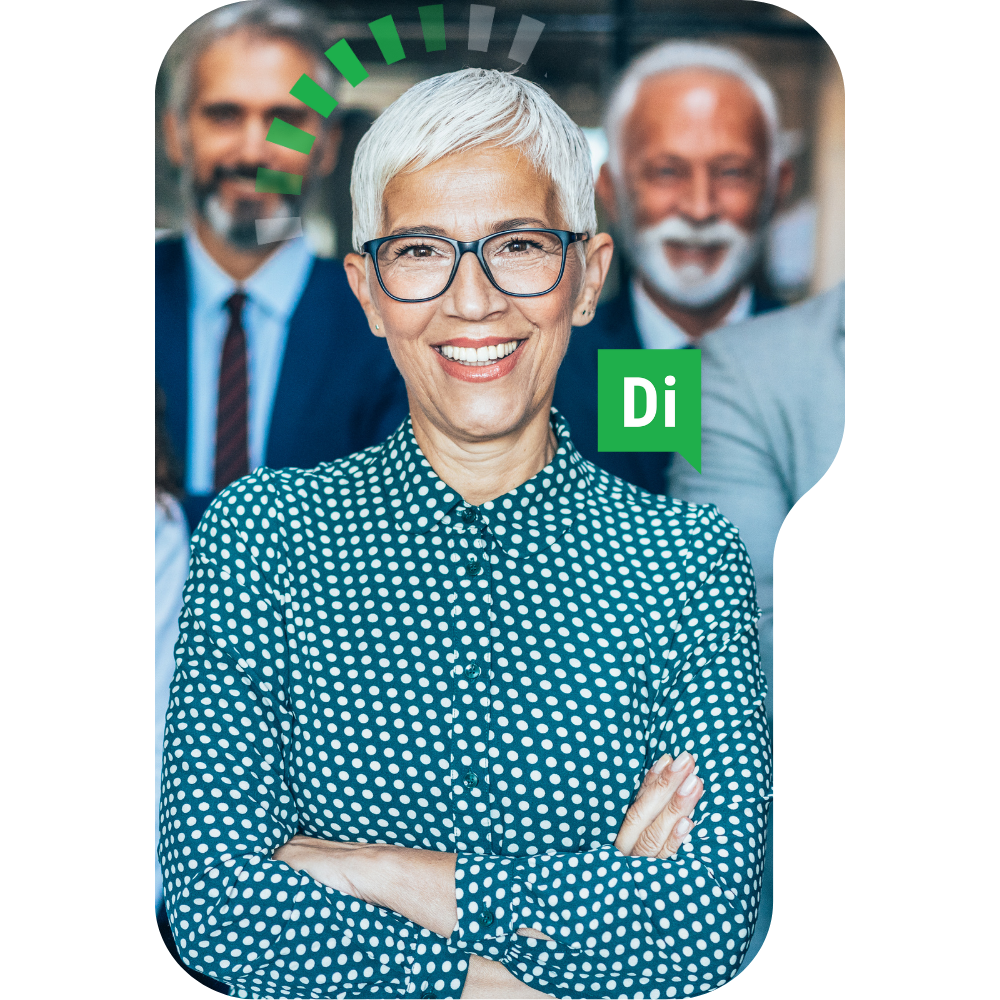 Smiling woman with short white hair and glasses, wearing a polka dot shirt, standing with crossed arms in front of two men in suits.