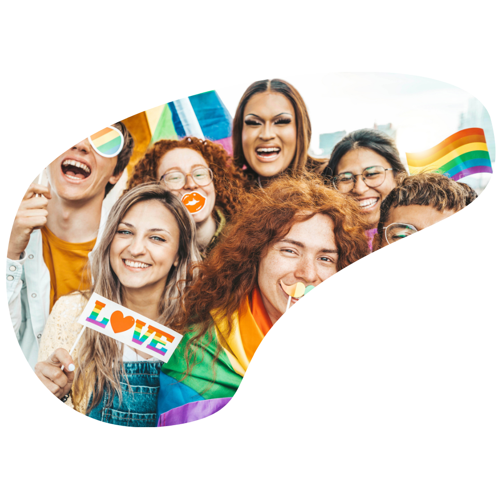 Group of diverse people at Pride celebration, holding rainbow flags, a sign that says "LOVE" with rainbow colors, and wearing rainbow accessories, outdoors in a city.